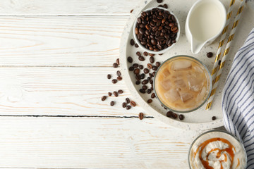 Composition with tray with ice coffee on wooden background