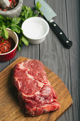 Raw steak, marbled beef, meat, dark background.