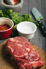 Raw steak, marbled beef, meat, dark background.