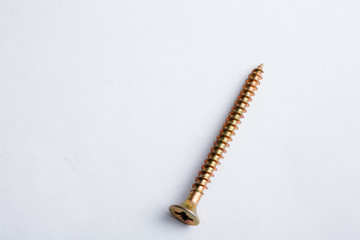 Self tapping yellow zinc coated screw, Flat head screw in high resolution macro closeup on white background