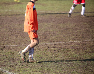 Fototapeta na wymiar Young soccer player in the mud
