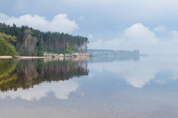Beautiful landscape of nature river, lake. A beautiful view of the reflection of nature and the sky on the water.