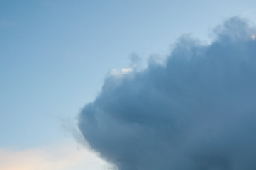 Rain clouds coming into blue sky in the atmosphere in the nature weather image.  Great for backgrounds and textures too.