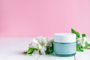 beauty, care jar of cream and white flowers