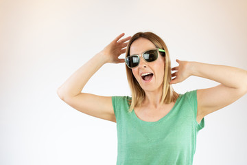 Beautiful woman laughing with glasses and green shirt