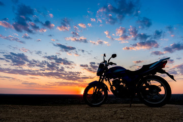 Obraz na płótnie Canvas Motorcycle on a beautiful sunset evening sky