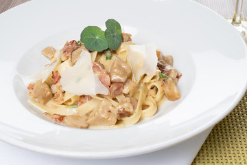 Tagliatele pasta with porcini, bacon and sage. Traditional Italian recipe from authentic cuisine