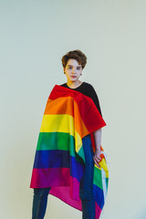 Beautiful lesbian girl wrapped in a rainbow flag