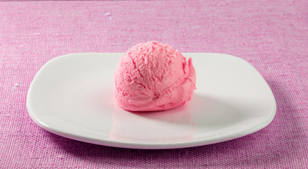 helado de fresa en plato sobre fondo rosa. strawberry ice cream in plate on pink background.