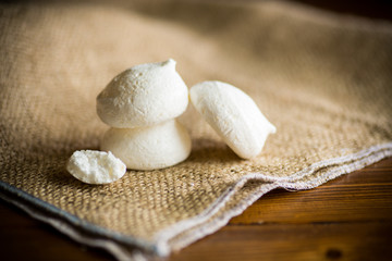 Fototapeta na wymiar sweet tasty white meringues on a wooden table