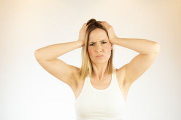 Fototapeta premium Pretty woman making a gesture with her hands on her head