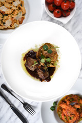 Lamb chops with baked baby potatoes and artichoke sauteed and red wine sauce . Traditional Italian