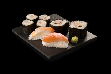 Sushi  de salmón y wasabi sobre fondo negro. Salmon and wasabi sushi on black background.