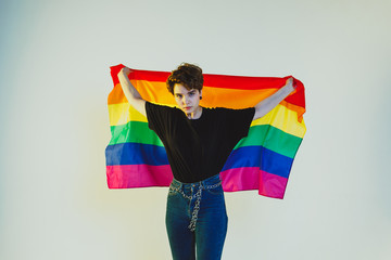 Beautiful lesbian girl holding a rainbow flag