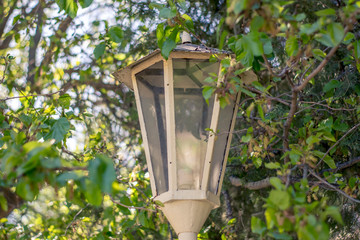 vintage style picture with old street lamp in the park