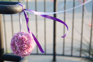 Close up of a flower at the entrance of a party.