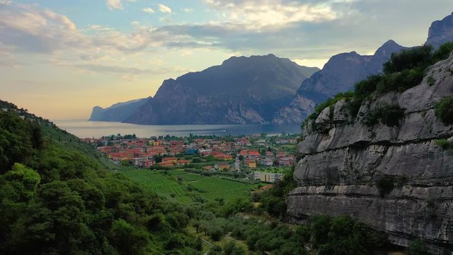 Panorama of Torbole a small town on Lake Garda, Italy. Europa, beautiful Lake Garda surrounded by mountains in the summer time at sunset