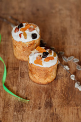 Delicious festive Easter cake near willow, easter celebration concept, flat lay view, festive food on wood backgroun