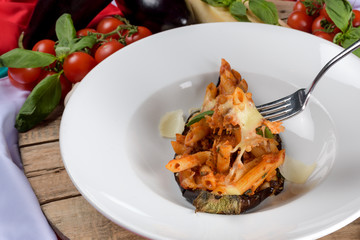 Penne with tomato sauce, eggplant, mozzarella. Vegetarian dish, traditional italian cuisine.