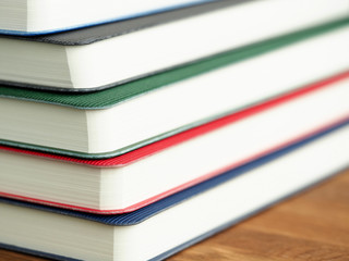 Close up stacked diaries or books, education