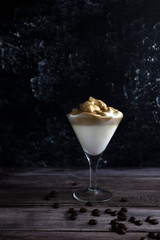 Dalgona coffee, Korean whipped coffee, cool fluffy whipped coffee. Latte espresso with coffee foam in martini glass, copy space