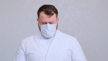 Male in a protective mask and a white shirt head bowed. Hygiene concept. prevent the spread of germs and bacteria and avoid infection with the crown virus. copy space