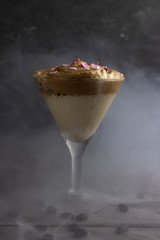 in a tall martini glass cold Dalgona Coffee, trendy Korean drink Dalgona coffee, whipped coffee with milk