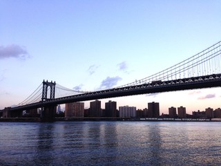 Fototapeta na wymiar Low Angle View Of Manhattan Bridge Over East River At Sunset