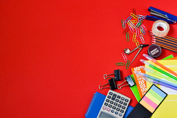 Education concept. Back to school. Top view of colorful school supplies on a red background. Place for text