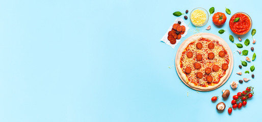 Making pizza pepperoni with raw dough and ingredients