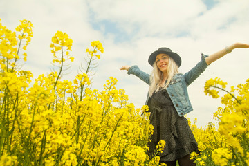 young woman in a rapeseed field