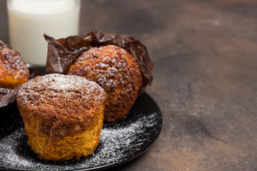 Freshly baked muffins with cacao, cinnamon and oat crumble topping on a natural wooden board