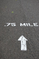 .75 Mile With Arrow Painted On Asphalt