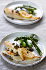 Lemon sole with butter and capers sauce and asparagus