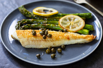 Lemon sole with butter and capers sauce and asparagus