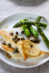 Lemon sole with butter and capers sauce and asparagus