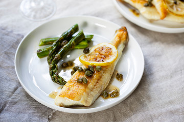 Lemon sole with butter and capers sauce and asparagus