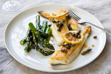 Lemon sole with butter and capers sauce and asparagus