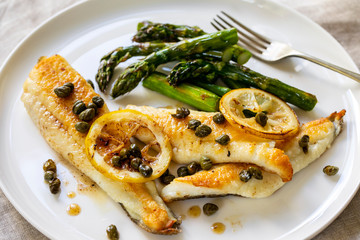 Lemon sole with butter and capers sauce and asparagus