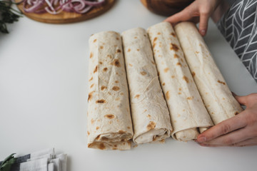 Cooking chicken roll with meat, fresh vegetables, herbs and sauce.