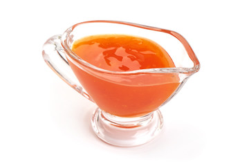 Sweet chili sauce in a gravy boat, isolated on white background