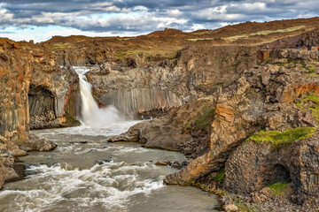 Fototapeta na wymiar Beautiful Icelandic waterfall at sunset with huge quantity of flowing waters Iceland