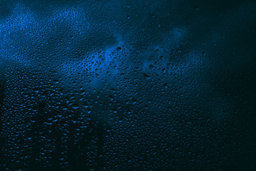 Blue raindrops on the glass