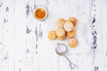 Fresh fried mini donuts sprinkled with powdered sugar