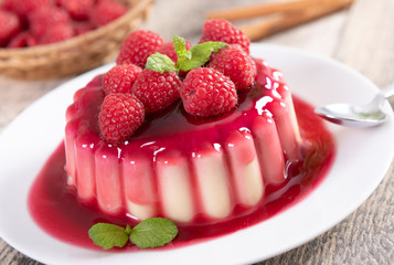 Delicious panna cotta dessert with raspberries sauce