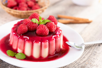 Delicious panna cotta dessert with raspberries sauce