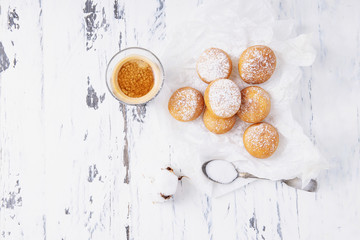 Fresh fried mini donuts sprinkled with powdered sugar