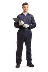 Naklejka na ściany i meble Young male worker in an overall uniform holding a clipboard with a document