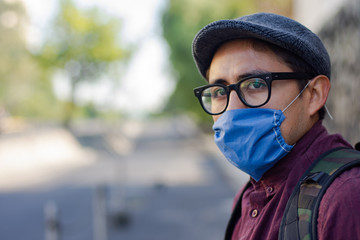 A man wearing a mask is walking on the street