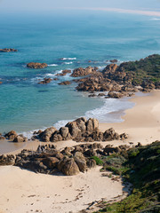 aerial view of seaside beach and rocks sunny day